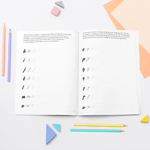 Letters of Resilience open at a letter practice spread, with colored pencils.