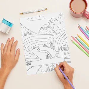 A hand colors a landscape of hills and clouds.