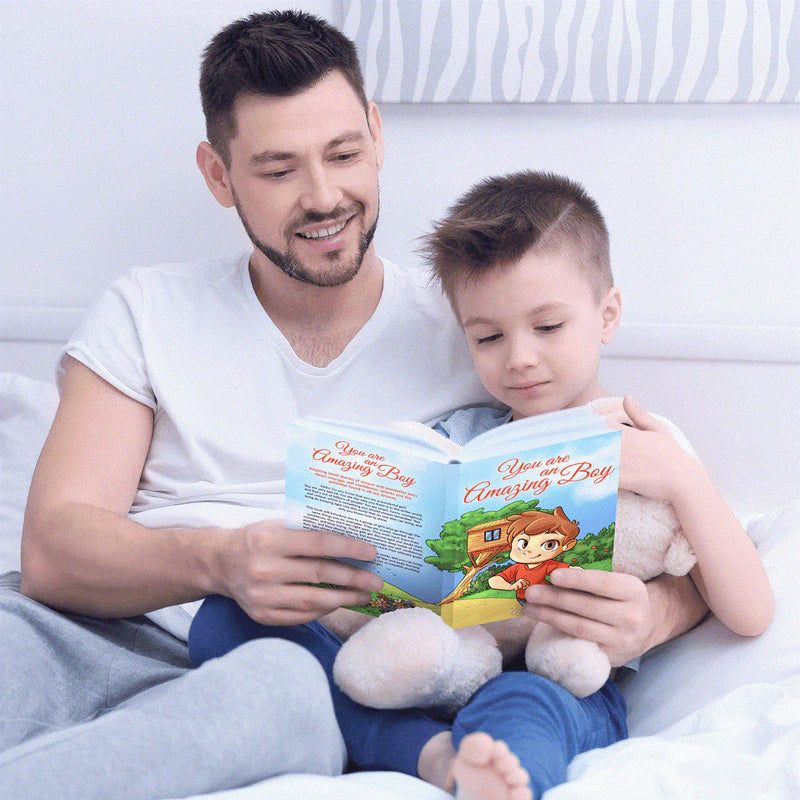 A father and his son read You Are an Amazing Boy together in bed.