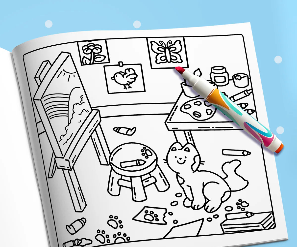Open book: a kitten among the easel, paints and paw prints