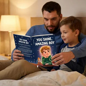 A father and his son read You Shine, Amazing Boy together in bed.