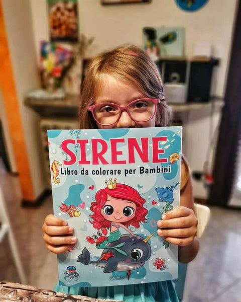 A girl holding the Italian coloring book Sirene