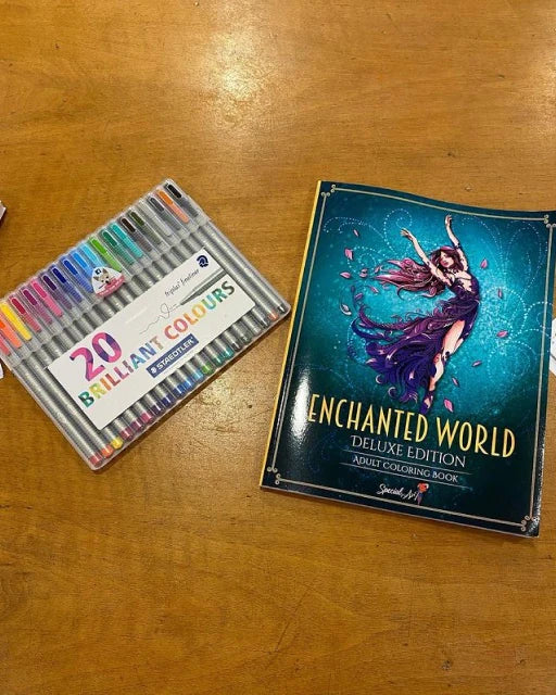 The coloring book Enchanted World with a set of markers